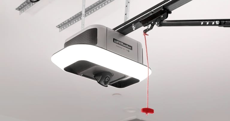 Ceiling-mounted garage door opener with rail and emergency release